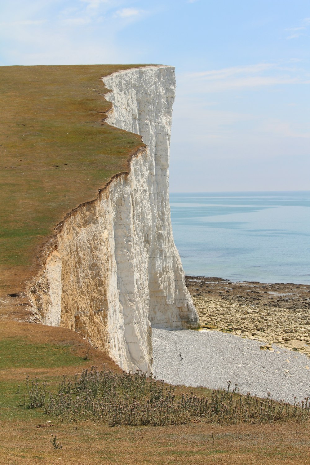 brown rock formation near body of water during daytime