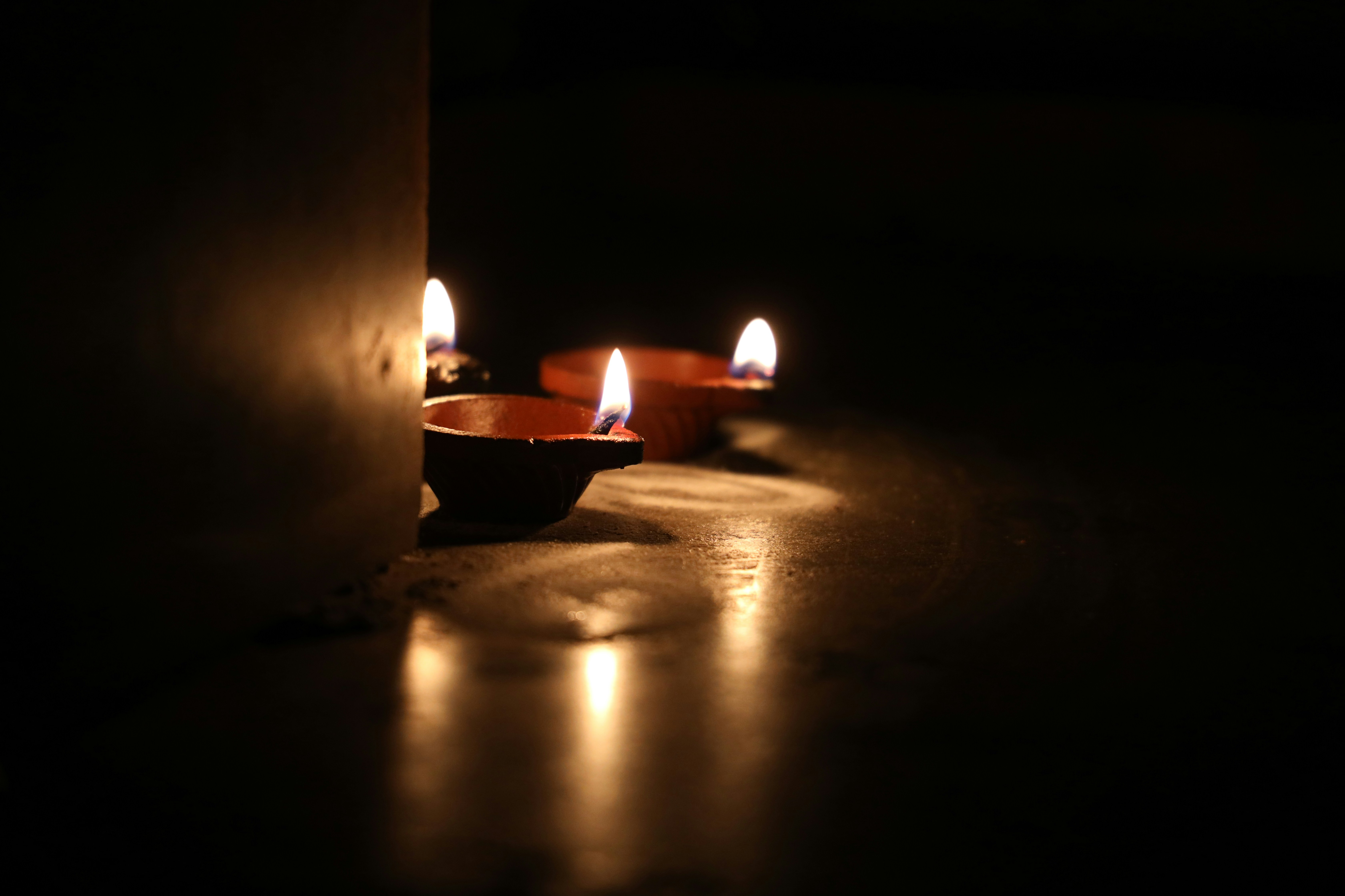 lighted candles on brown wooden bowl