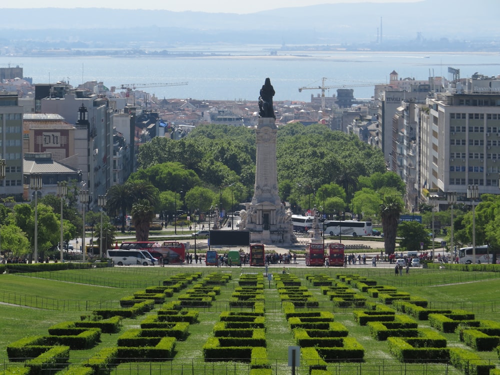 green grass field near city buildings during daytime