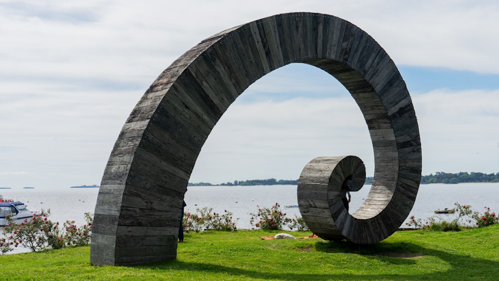 green grass field under gray concrete arch during daytime