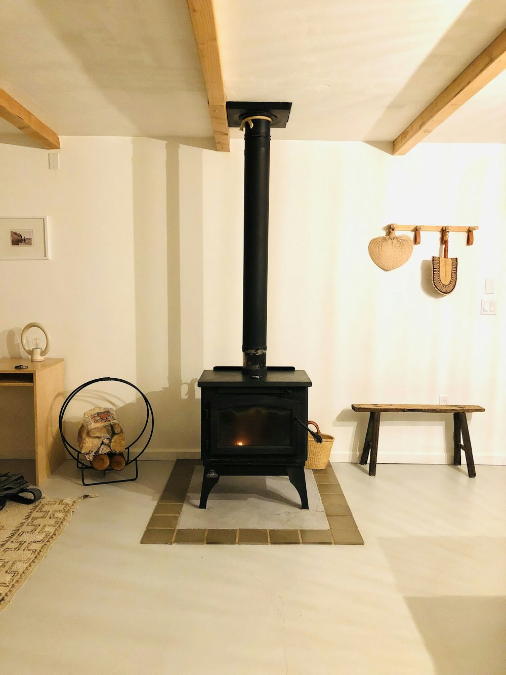 black wood burner near white wall