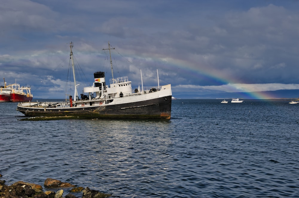 white and brown ship on sea under blue sky during daytime