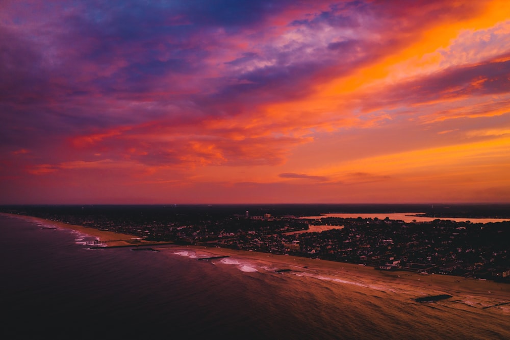 body of water under cloudy sky during sunset