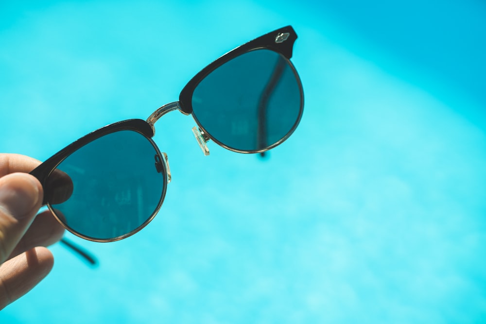 black framed sunglasses under blue sky during daytime