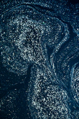 A swirling indigo galaxy with warm gold stars twinkling against a deep cosmic backdrop.