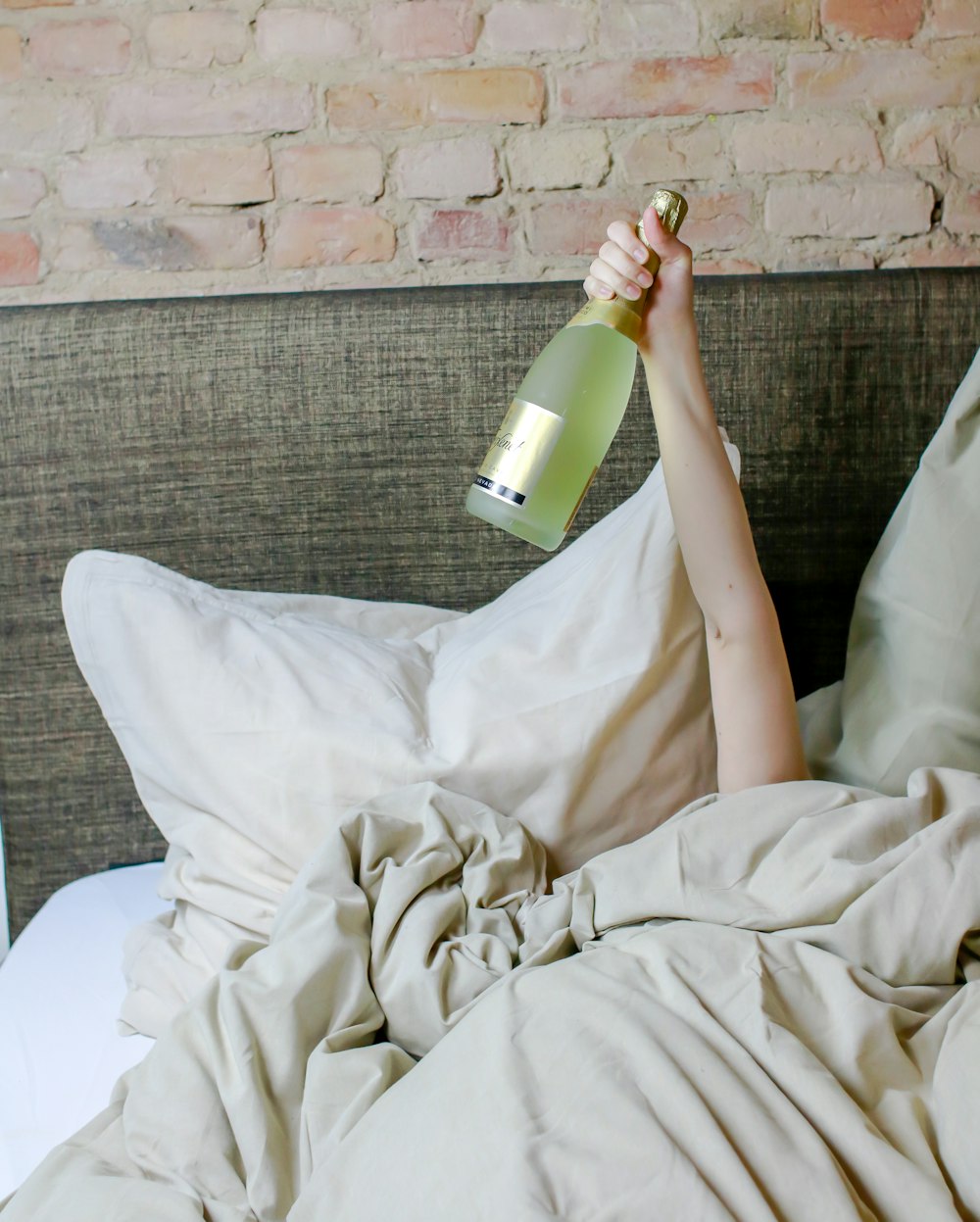 person holding green and white bottle