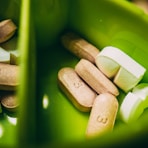 white medication pill on green plastic container