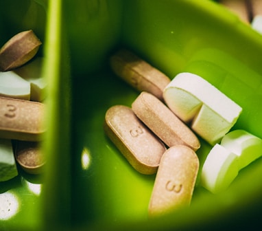 white medication pill on green plastic container