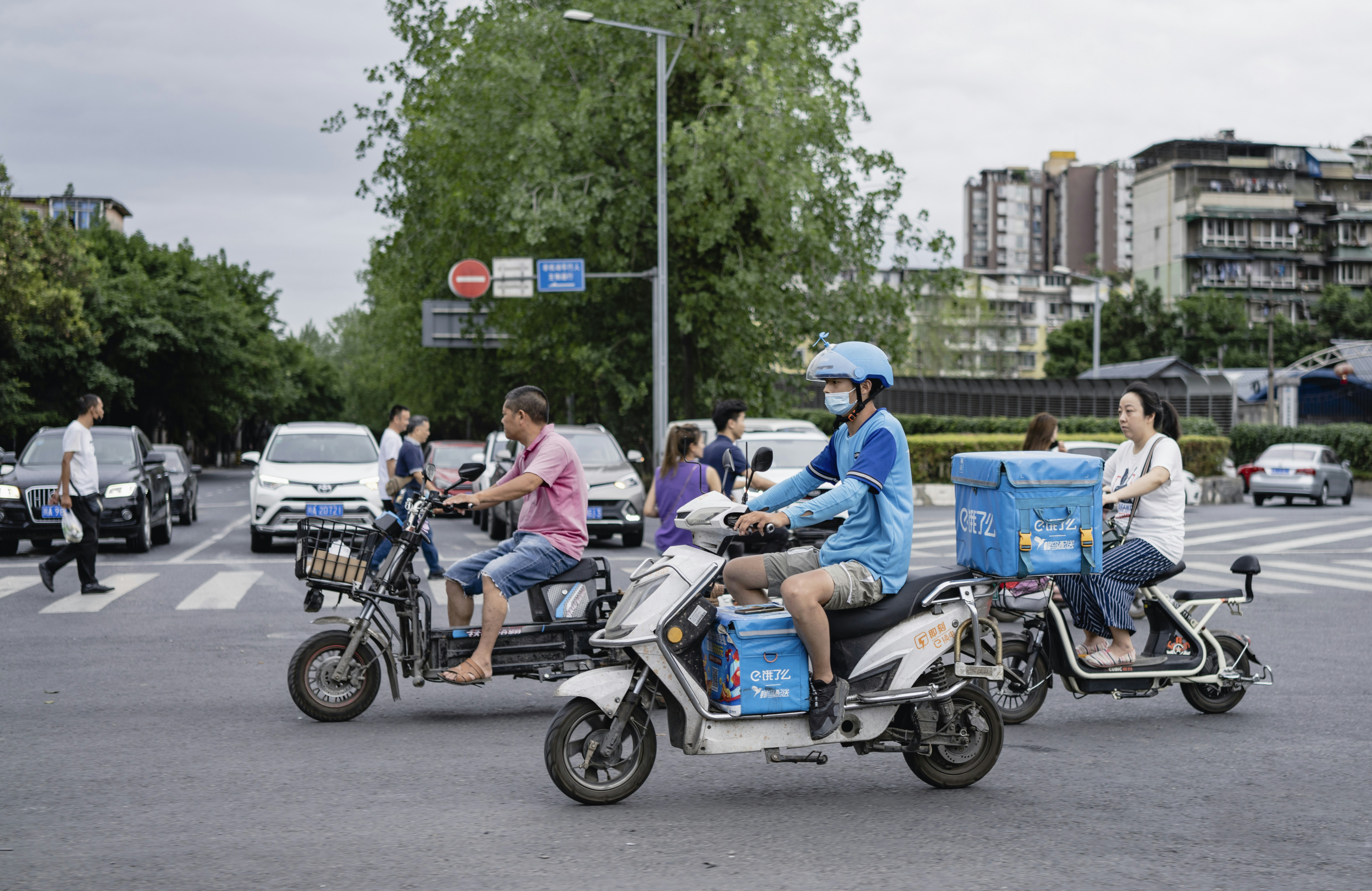 people riding motorcycle on road during daytime