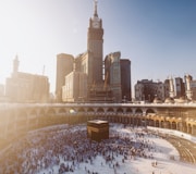 people walking on snow covered field near brown concrete building during daytime