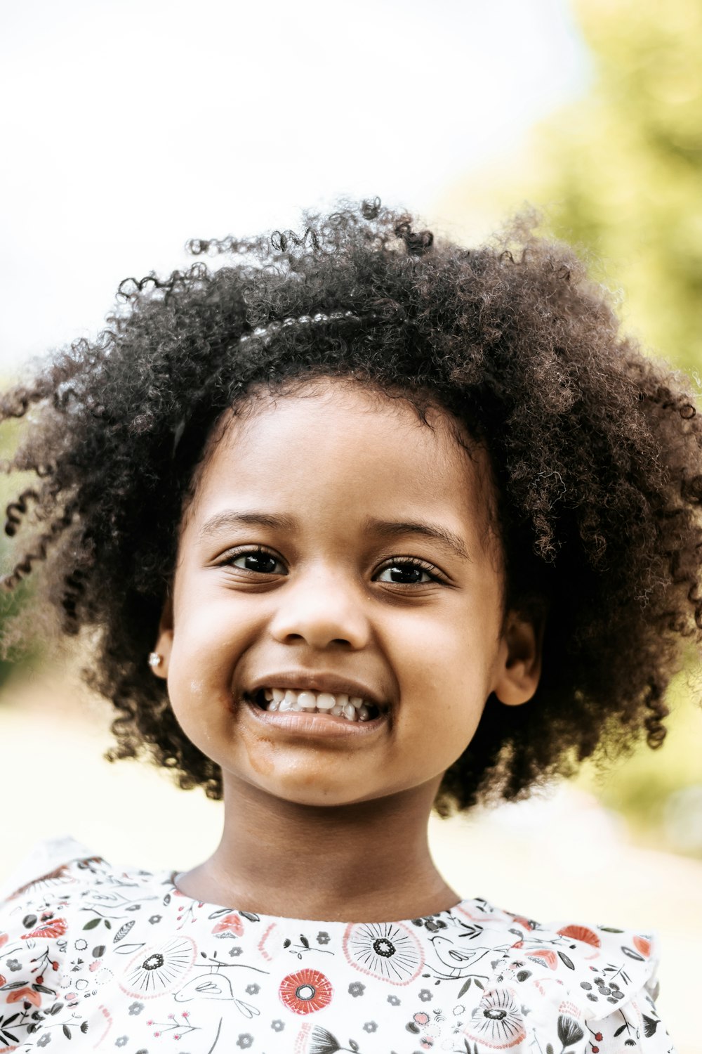 girl in white crew neck shirt smiling