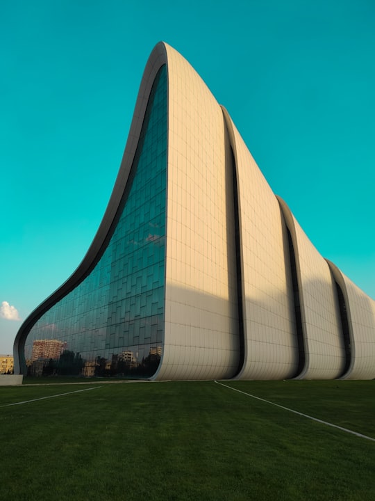 white concrete building under blue sky during daytime in Baku Azerbaijan