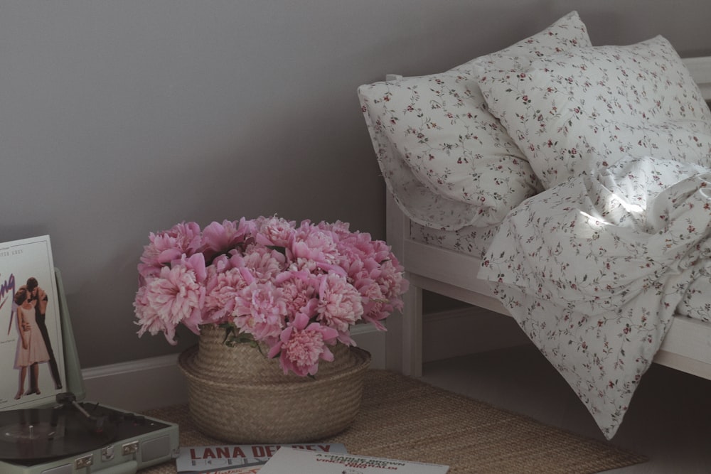 pink flowers on brown woven basket