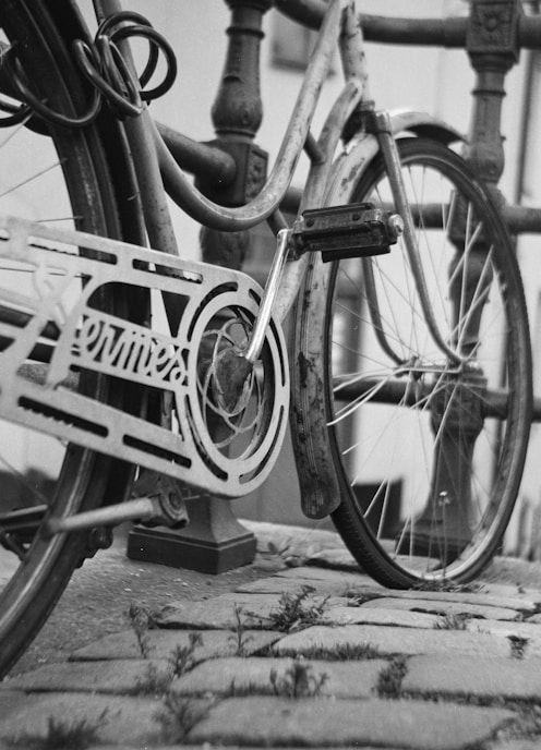 grayscale photo of bicycle on road