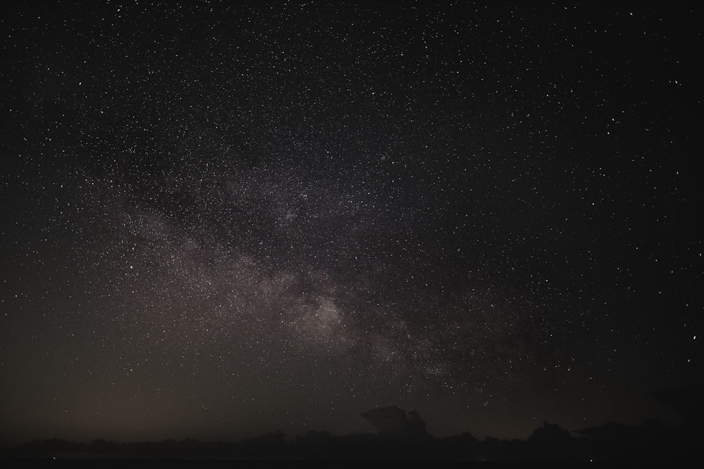 silhouette of mountain under starry night