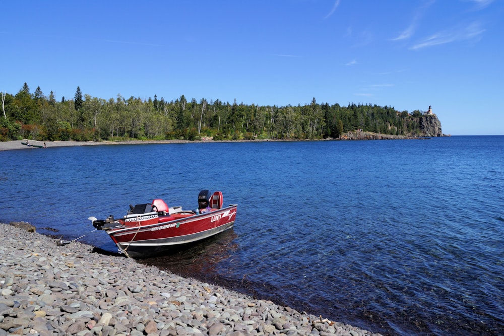 red and white boat on blue sea water during daytime