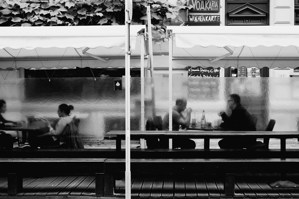 grayscale photo of people in a restaurant
