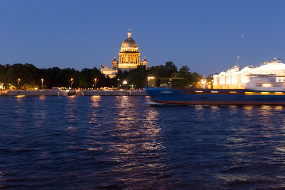 white and brown dome building near body of water during night time