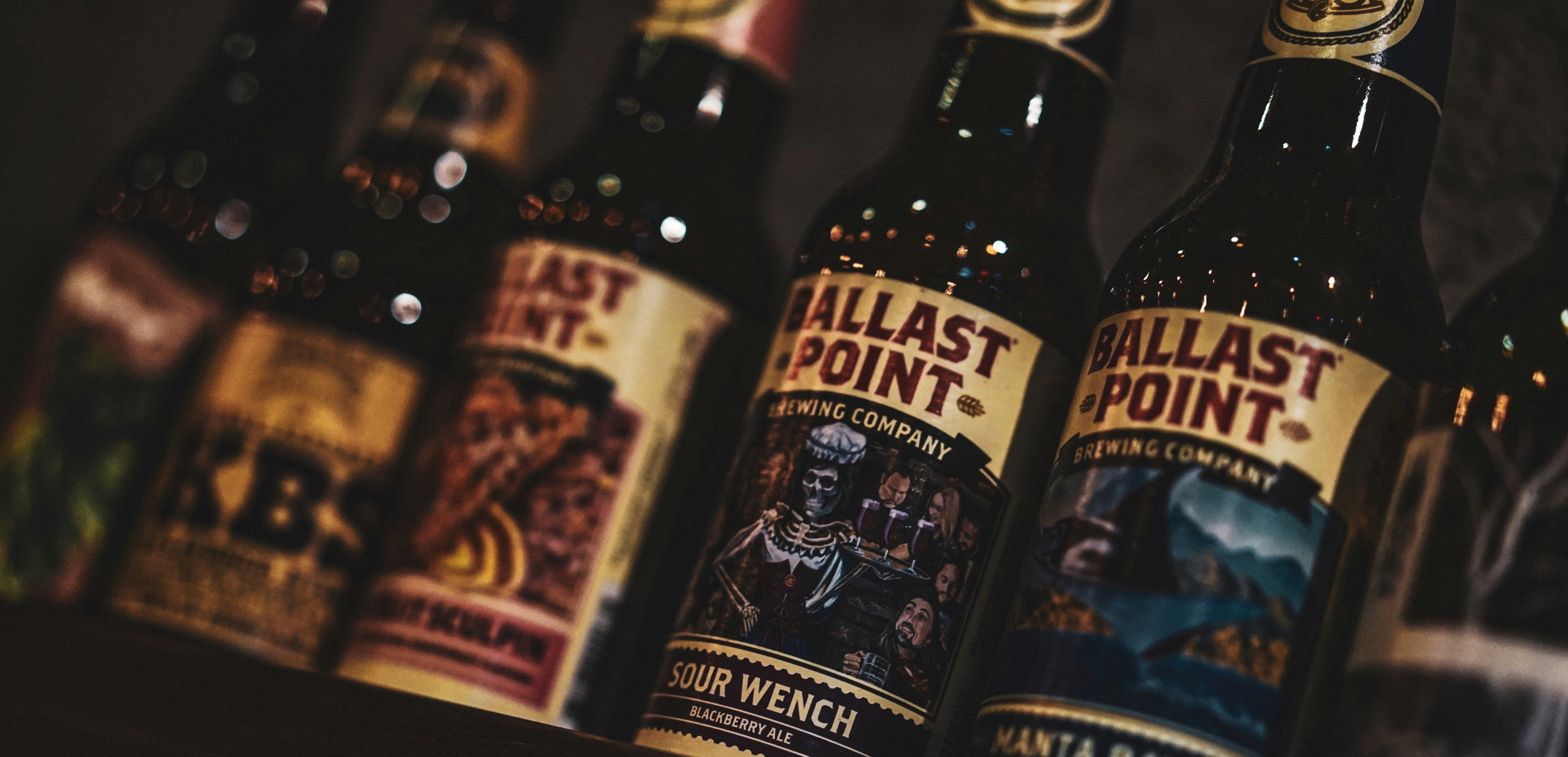 three black and yellow labeled bottles