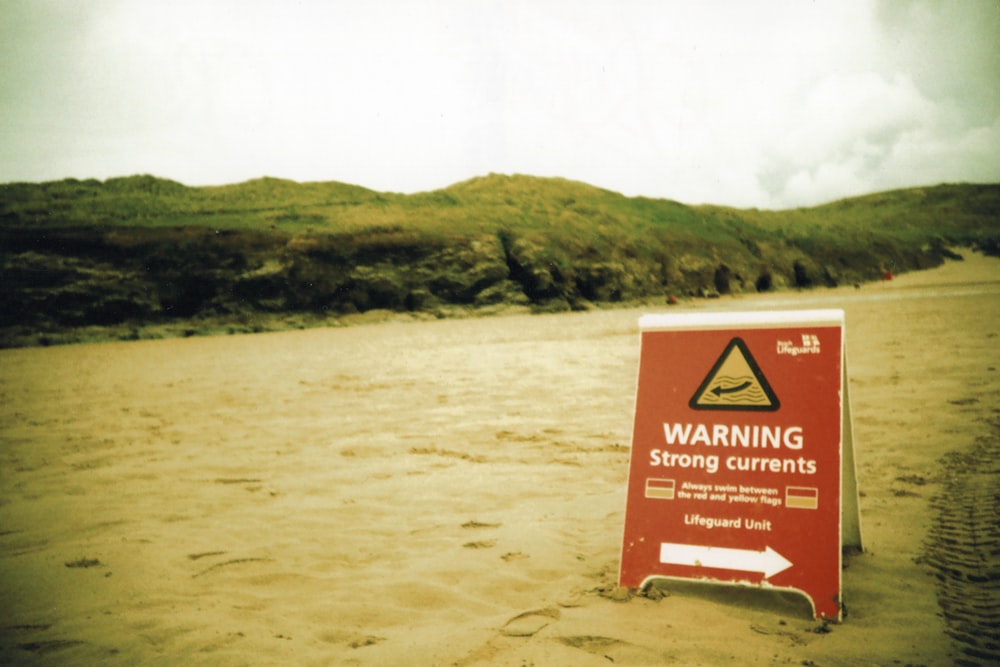 brown and white signage on brown sand during daytime