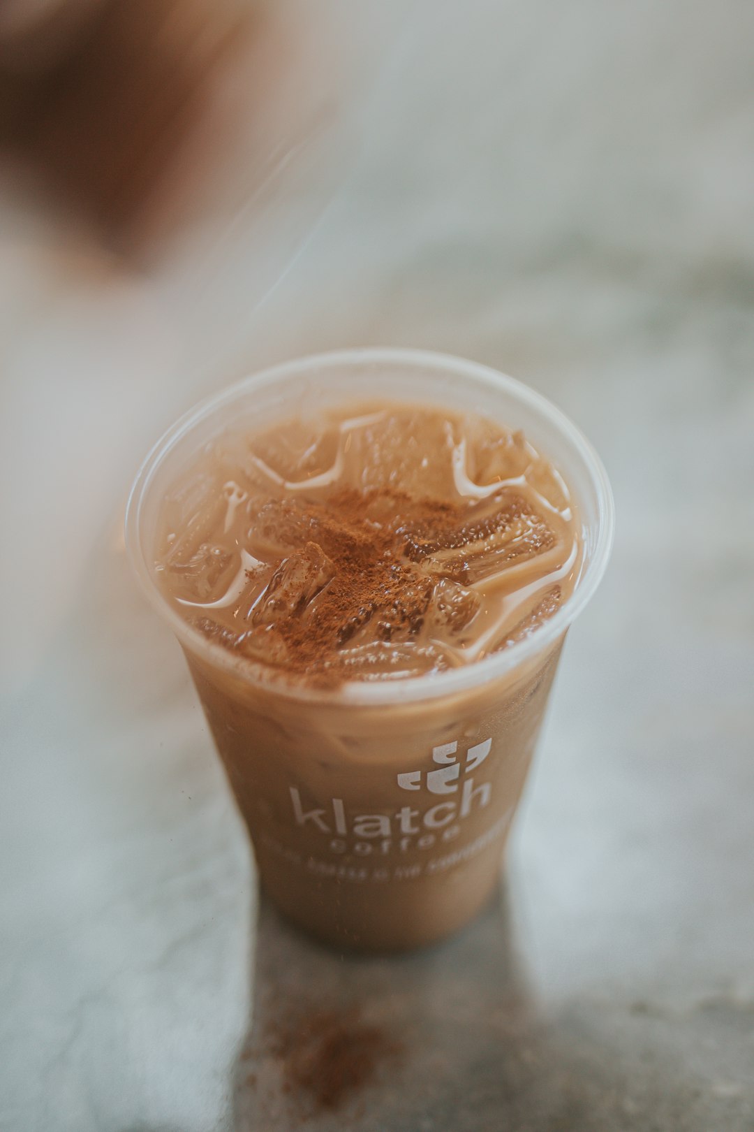 clear plastic cup with brown liquid