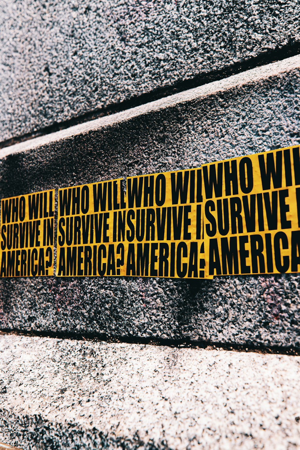 yellow and black quote on gray concrete wall