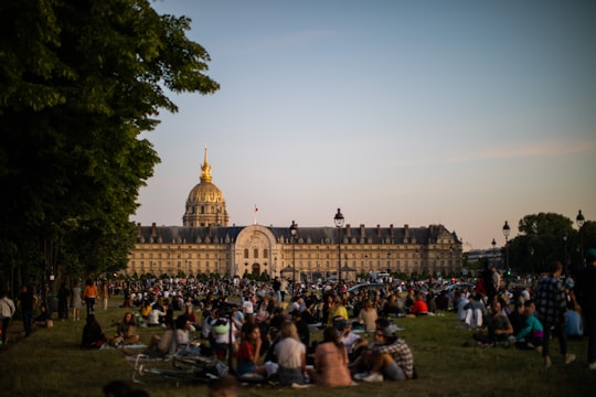people walking on green grass field near brown concrete building during daytime in Les Invalides France