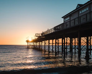 Sunset over Eastbourne pier with golden light reflecting on the water