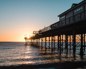 Sunset over Eastbourne pier with golden light reflecting on the water