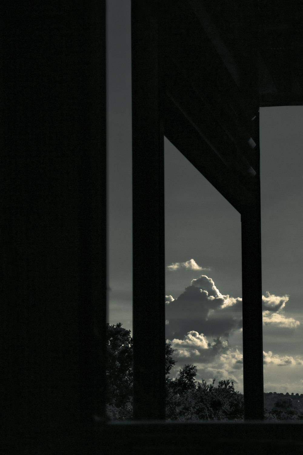 silhouette of trees under cloudy sky during daytime