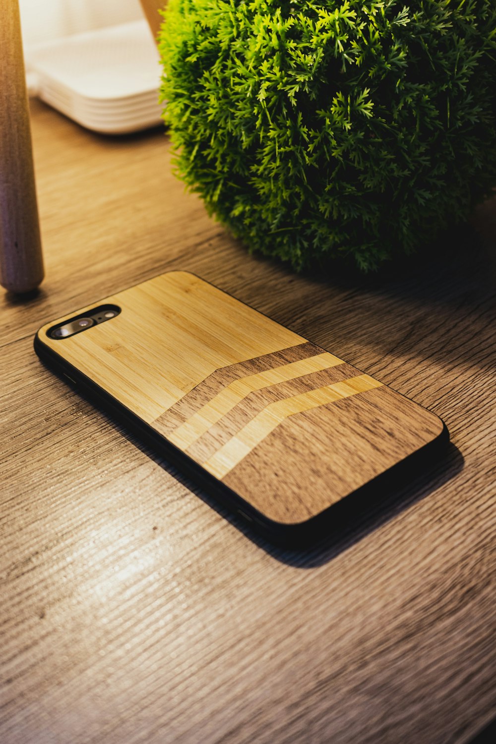 black iphone 7 on brown wooden table