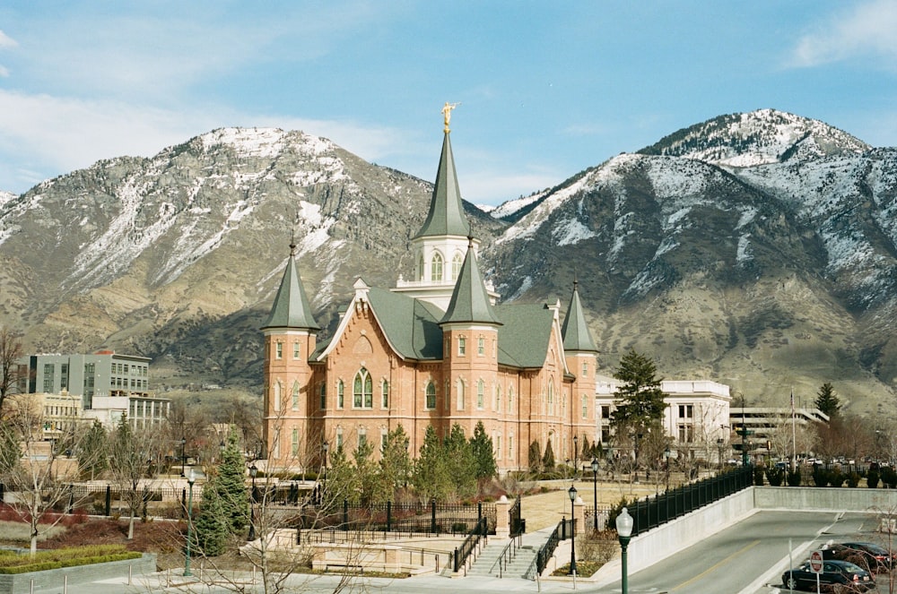 brown and gray concrete building near mountain under blue sky during daytime