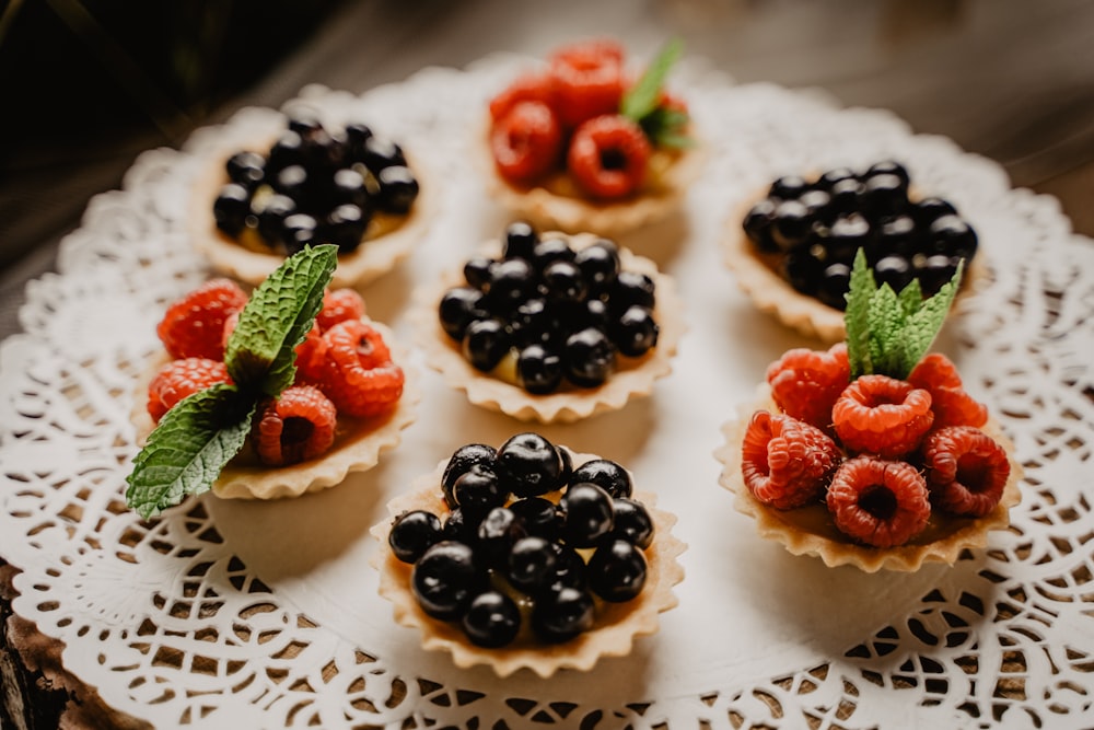 strawberry and blackberry on white ceramic plate