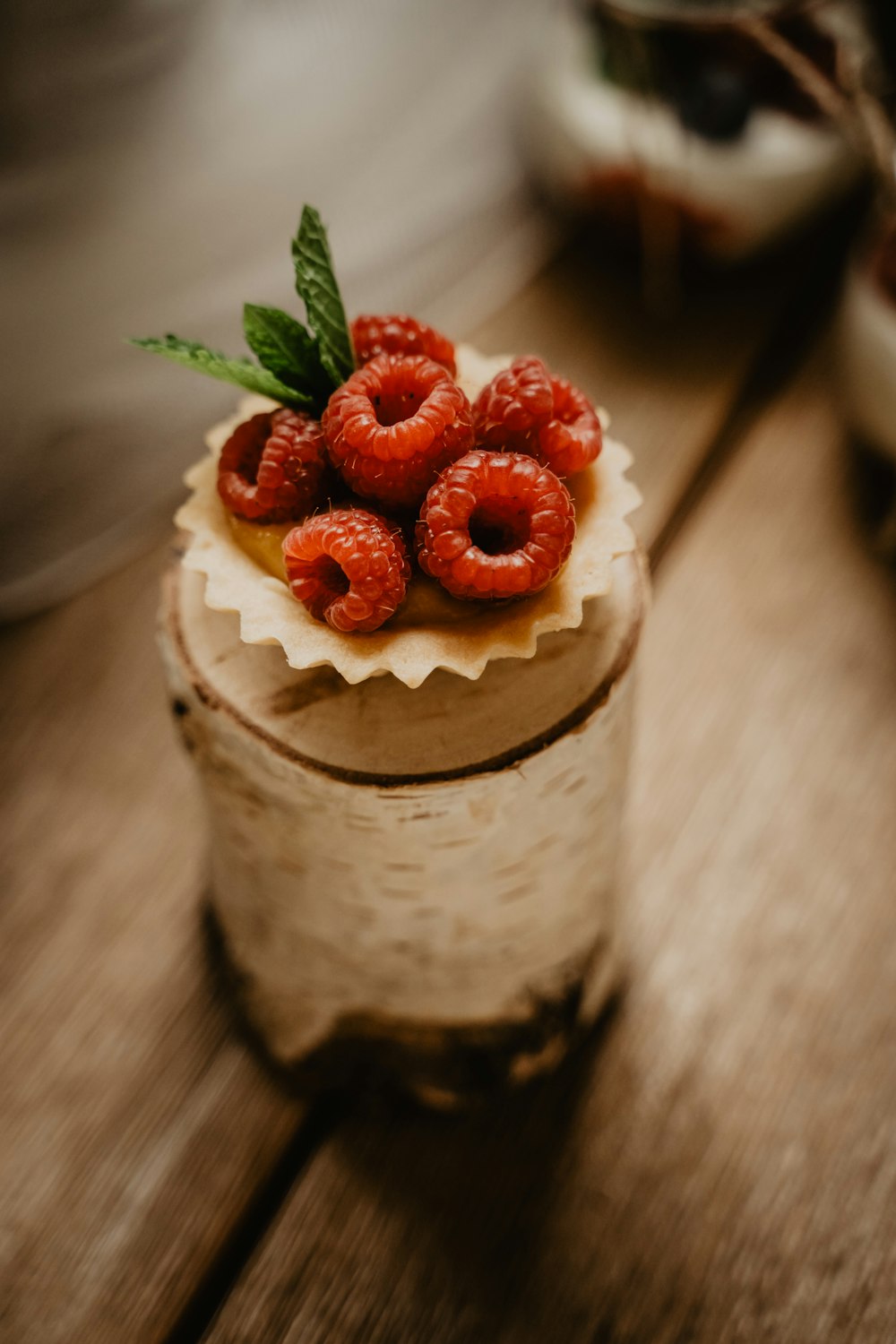 strawberry and blueberry on white and brown cupcake