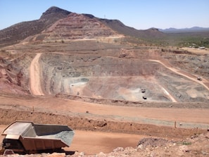 SLRRI team members inspecting a diamond mining site under bright sunlight.