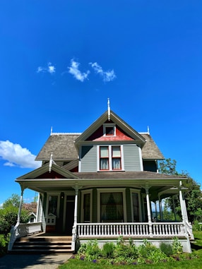 white and brown wooden house under blue sky during daytime