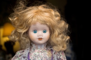 girl doll in blue and white floral dress