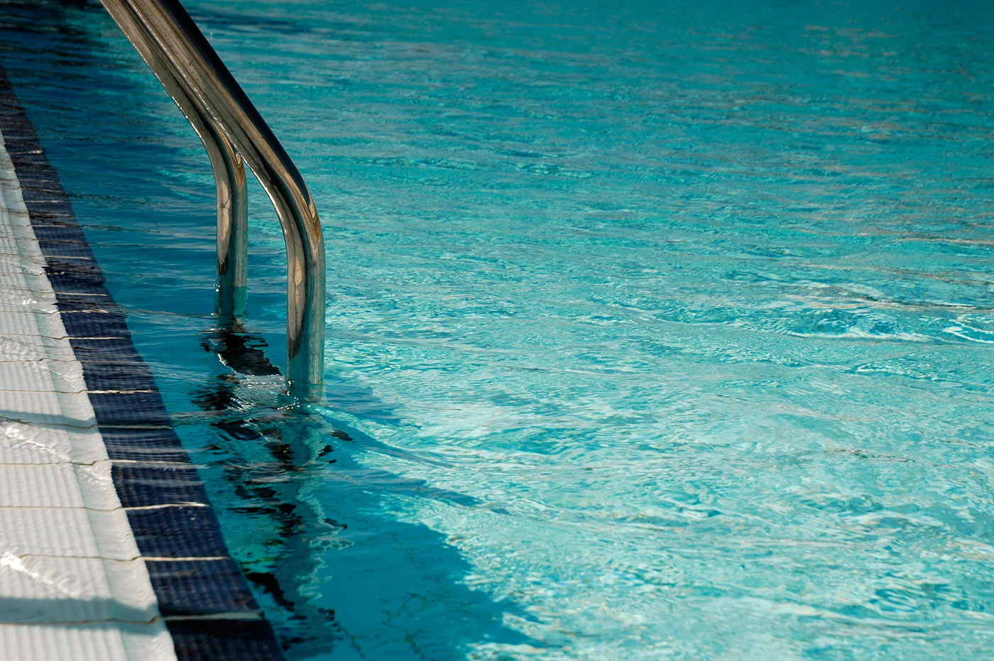 Clear blue swimming pool water after algae treatment