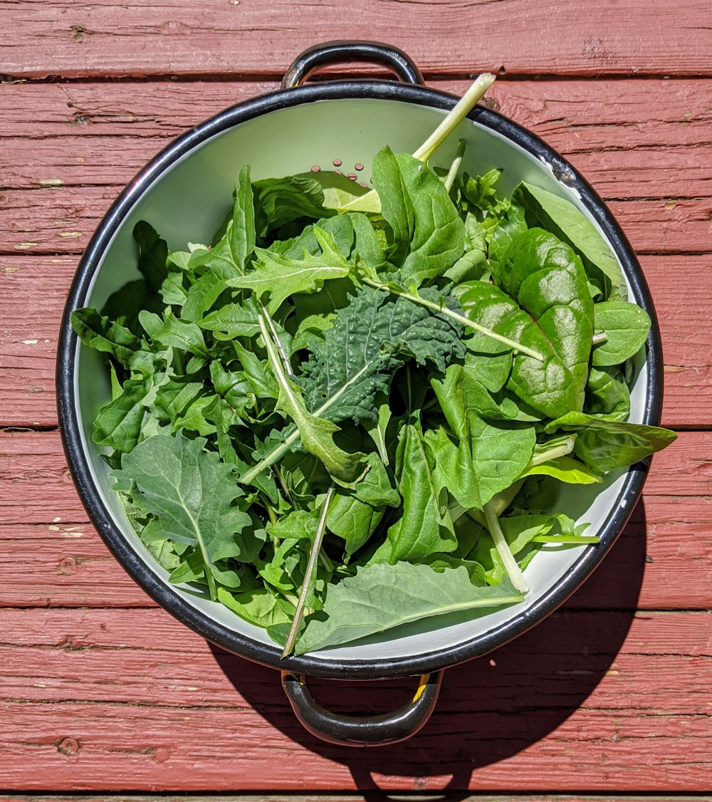 green vegetable in blue ceramic bowl