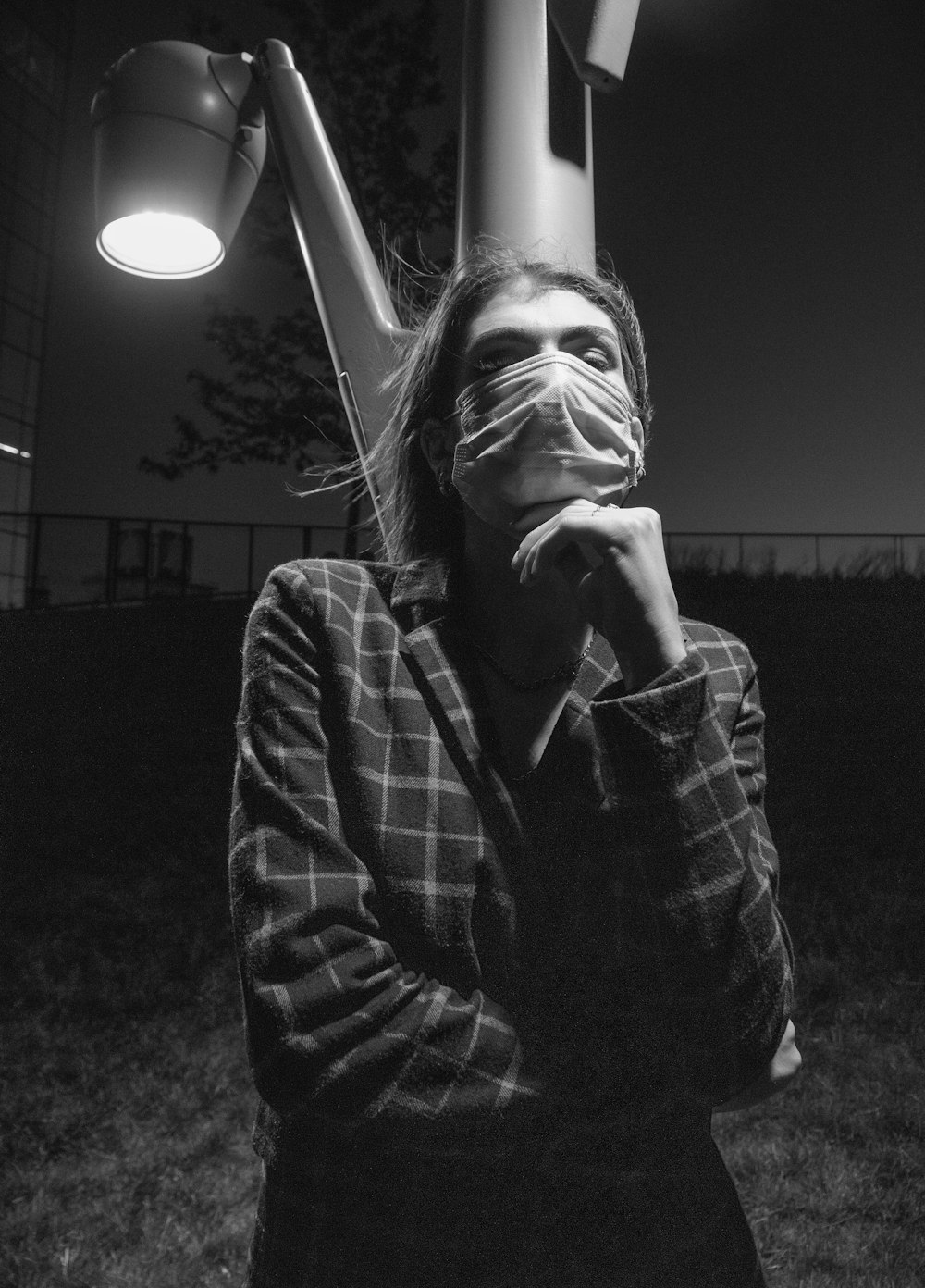 grayscale photo of woman covering her face with her hands