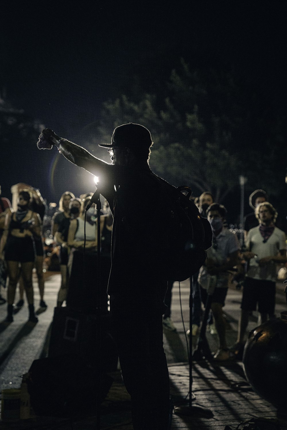 man in black jacket singing on stage