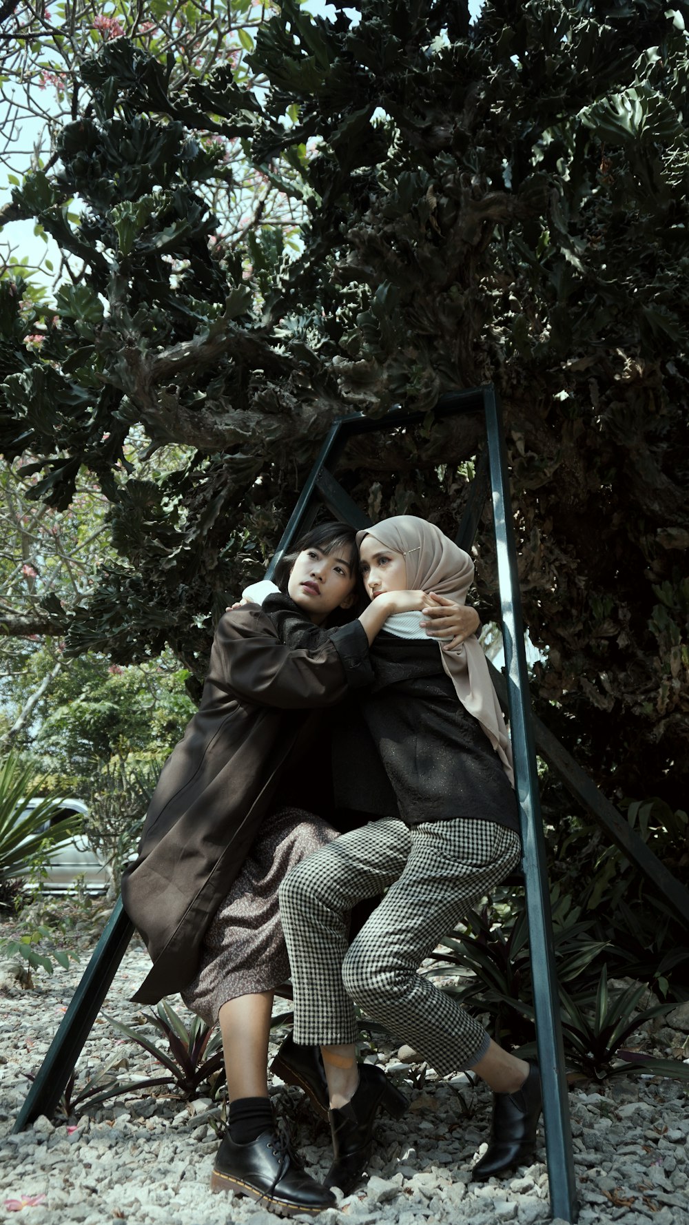 woman in black jacket sitting on swing chair