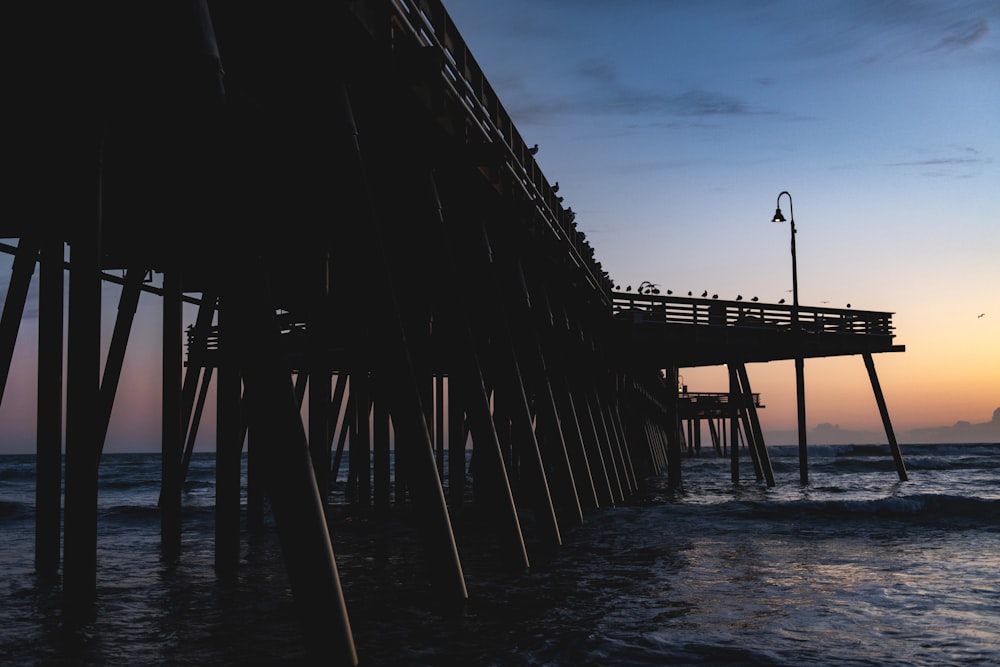 brown wooden dock on sea during daytime