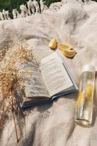 white book page beside clear glass bottle