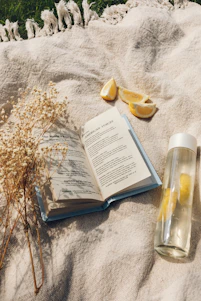 white book page beside clear glass bottle