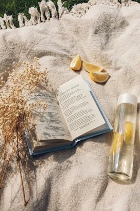 white book page beside clear glass bottle