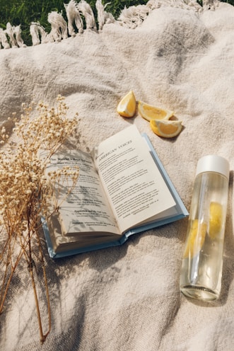 white book page beside clear glass bottle