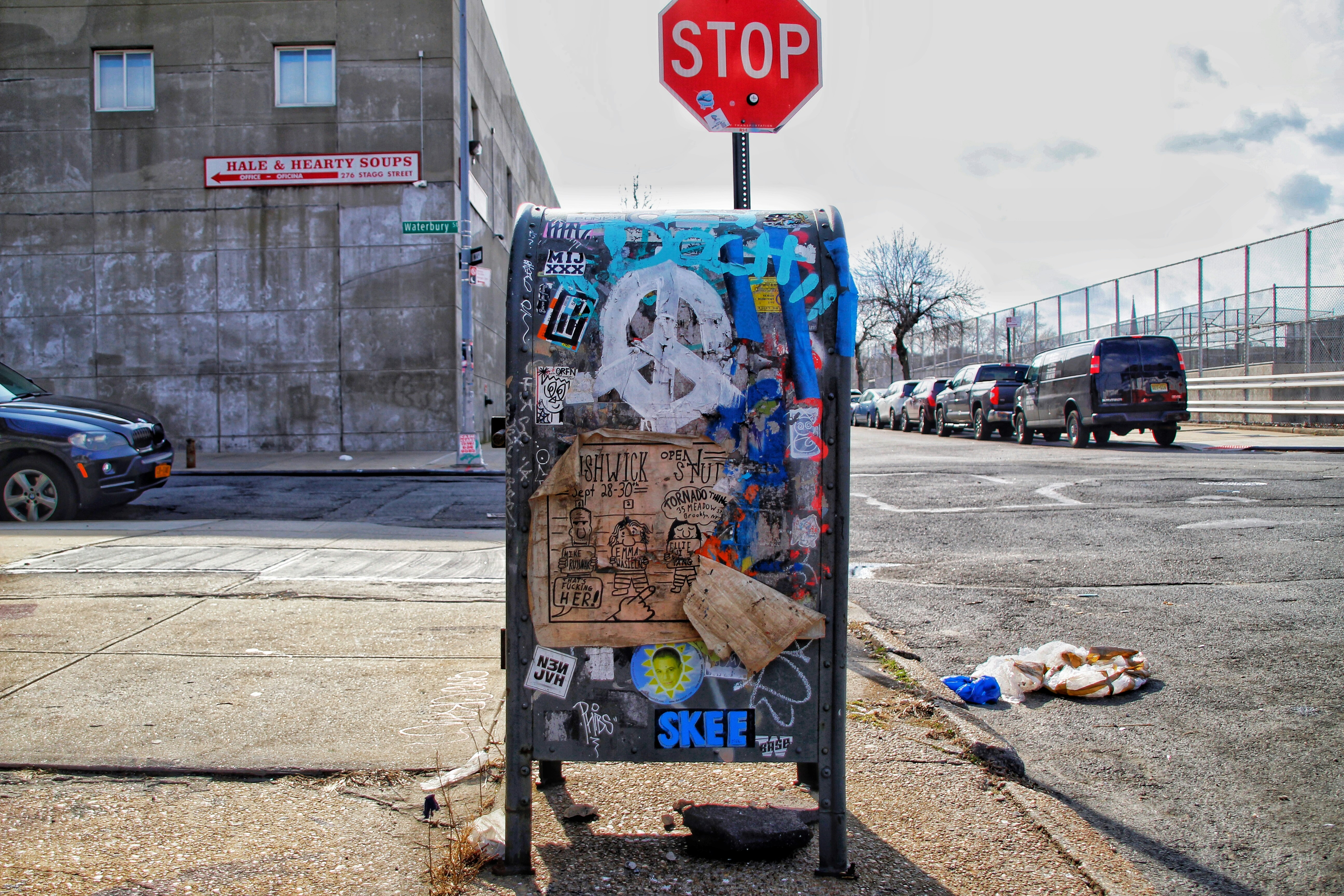blue red and white stop sign, A colorful corner in Brooklyn, New York.