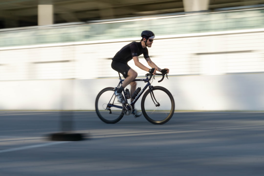 man in black shirt riding on bicycle