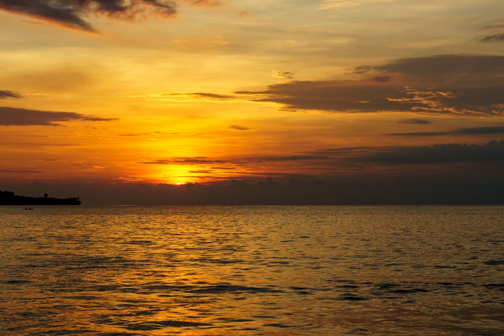 body of water during sunset